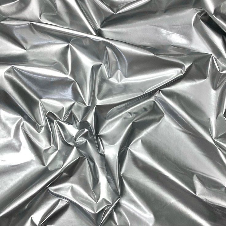 an up close shot of shiny silver fabric that looks like it could be used as a background