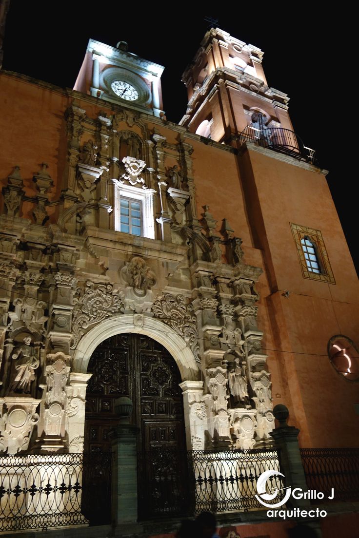 an ornate building with a clock tower at night