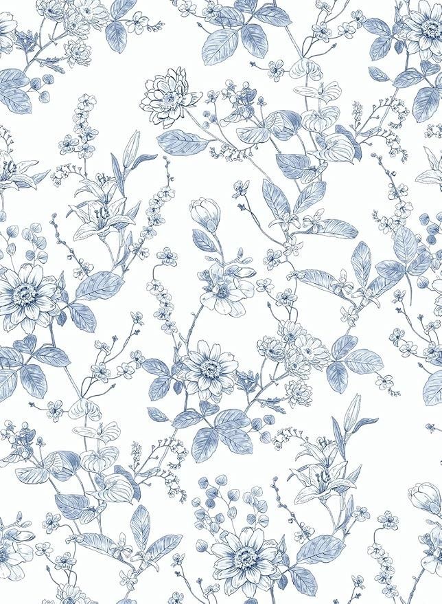 a blue and white floral wallpaper with small flowers on the left side of it