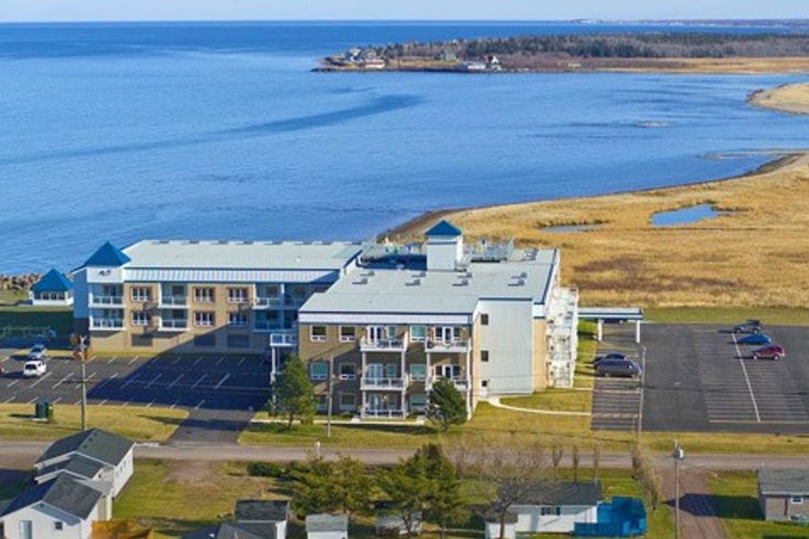 an aerial view of several buildings near the water