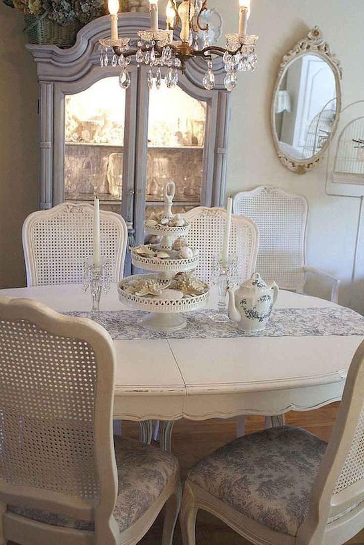 a dining room table with chairs and a china cabinet in the backround area