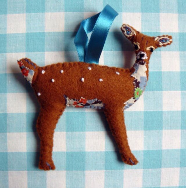 a deer ornament hanging on a blue and white checkered table cloth