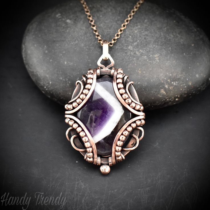 Star amethyst  free flow wire wrapped pendant Product detail:- This beautifully handcrafted pendant is made of star amethyst cabochon which is wrapped in pure copper wire in a free-flow style. This pendant is oxidized for an antique look and polished to highlight the details of the wirework. It comes with a matching chain in the length of your choice. Material used:- * Pure copper wire. * Star amethyst stone. * Copper beads Measurements:- Height- 5.3 cm  Width- 3.2 cm  Protection:- Copper will be tarnished after a while so try to limit contact with lotions, soaps or anything moist and never wear it in the shower, swimming or anywhere else it may come in contact with water. If tarnish becomes an issue, you may clean this item with jewelry cleaning cloth or ultra polishing pads. Packing:- Yo Pendant Wire Wrapping, Wire Star, Copper Wire Art, Wire Wrapped Jewelry Diy, Wire Jewelry Designs, Wrapped Necklace, Wire Work Jewelry, Wire Pendant, Work Jewelry