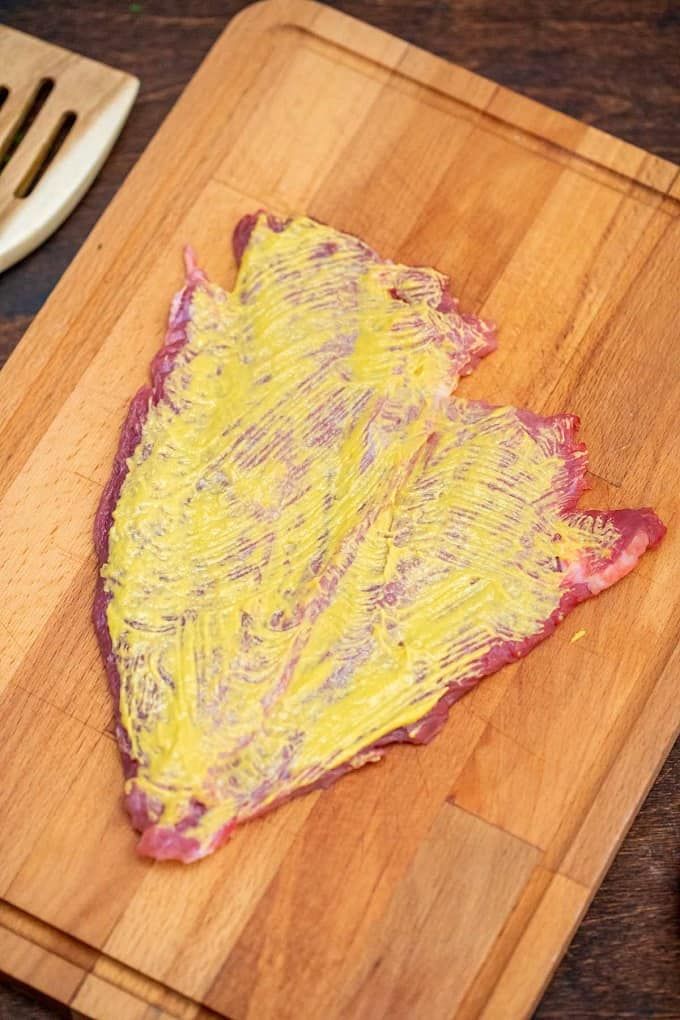 a piece of meat on a wooden cutting board