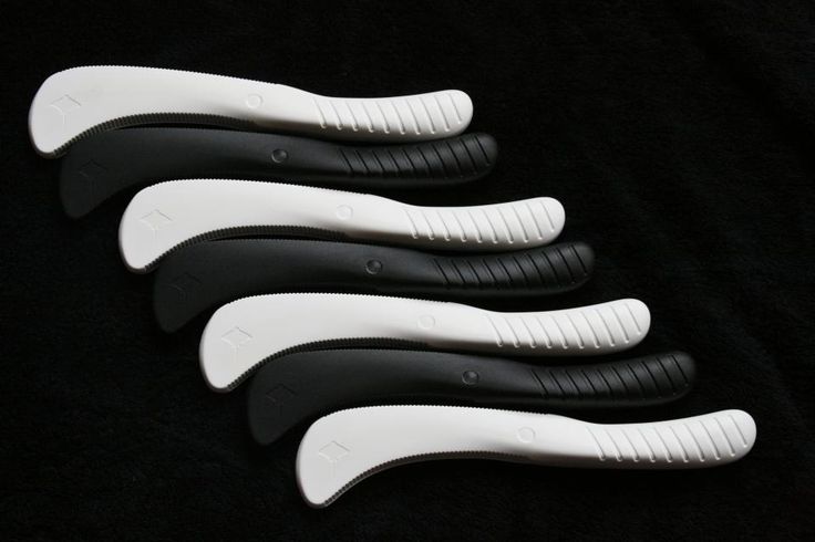 five black and white toothbrushes lined up in a row