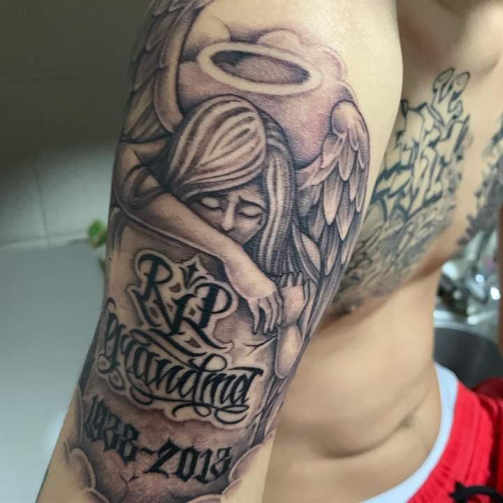 a man's arm with an angel tattoo on it and the words red riding