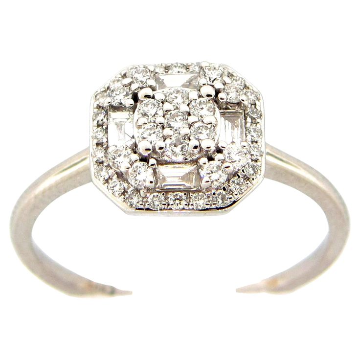 This stunning ring features a beautiful Cushion Cluster of White Diamonds comprising of Baguette and Round Diamonds. This ring is set in 18K White Gold. Total Diamond Weight = 0.42 Carats. Ring Size is 6 1/2. Diamond Ring With Baguette Diamonds In Octagon Shape, 14k White Gold Diamond Ring With Baguette Diamonds, 14k White Gold Baguette Diamond Ring, Formal Cluster Diamond Ring With Baguette Diamonds, White Gold Baguette Diamond Rings For Anniversary, Dazzling Baguette Diamond Ring For Formal Occasions, Anniversary White Gold Rings With Baguette Diamonds, Octagon White Gold Diamond Ring With Baguette Diamonds, White Gold Octagon Diamond Ring With Baguette Diamonds