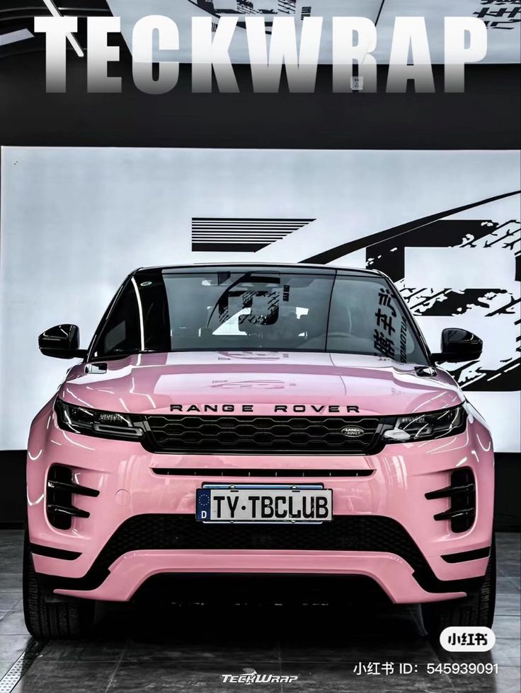 a pink range rover is parked in front of a building with the words teckwrap on it