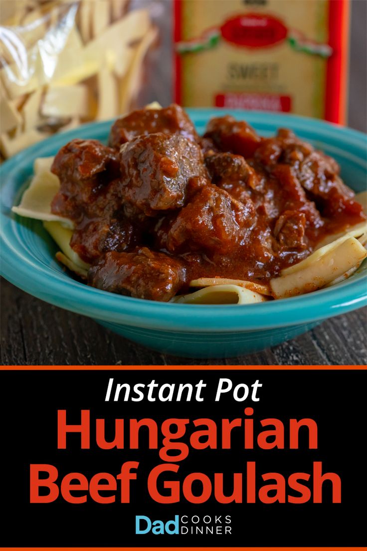 the instant pot hungarian beef goulash is served in a blue bowl with noodles