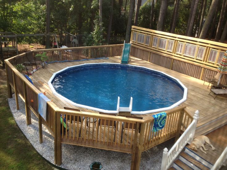 an above ground pool surrounded by wooden decking