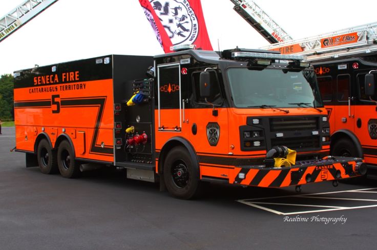 an orange fire truck parked in a parking lot