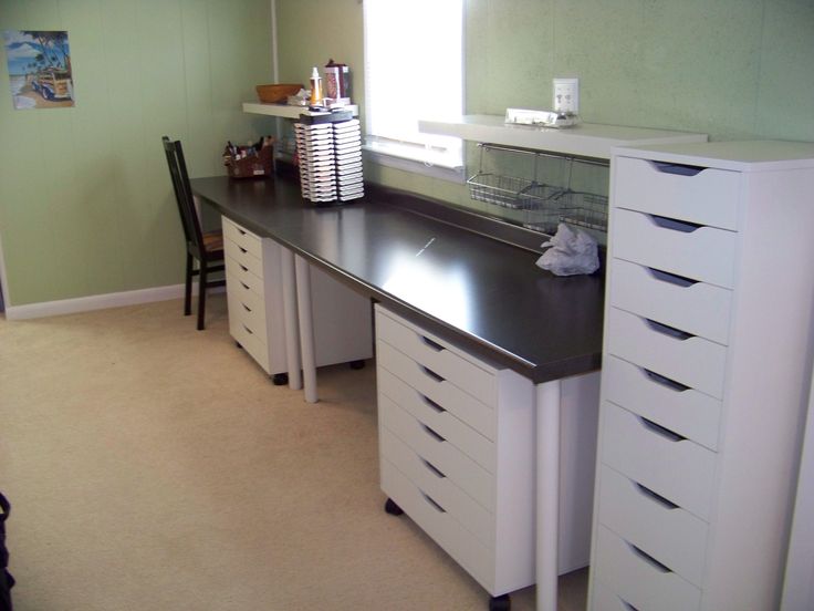 a room with a desk and several drawers