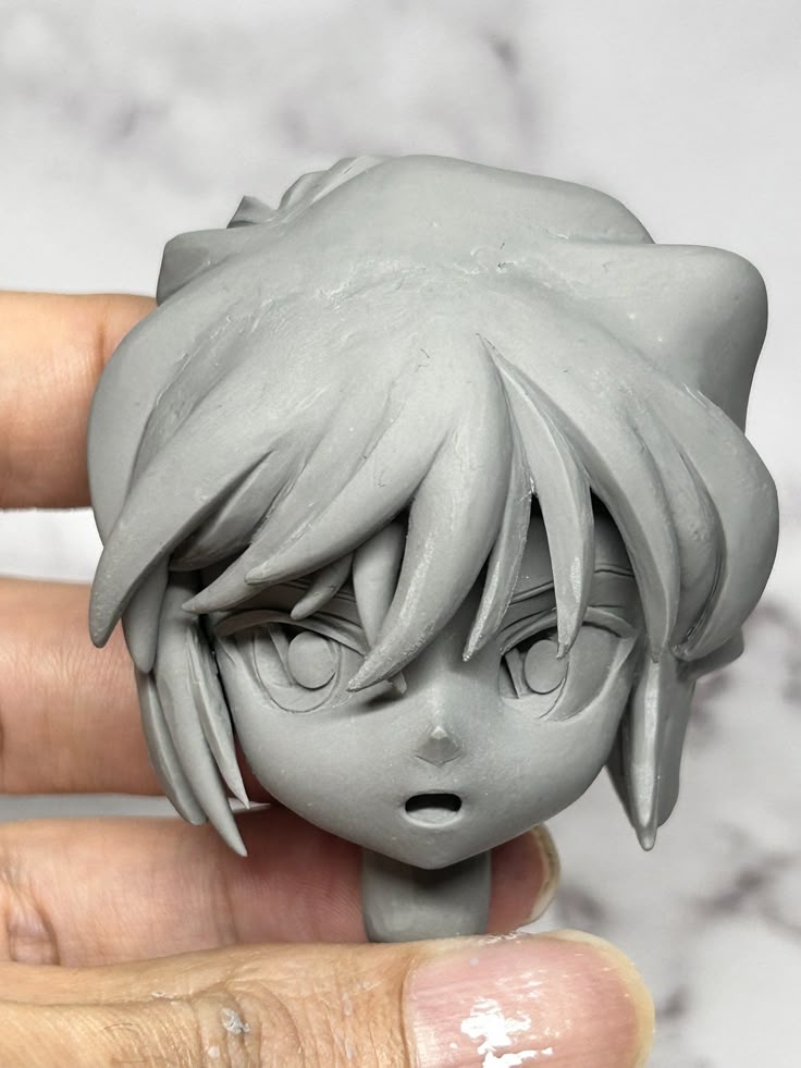 a close up of a person holding a small figurine in front of their face