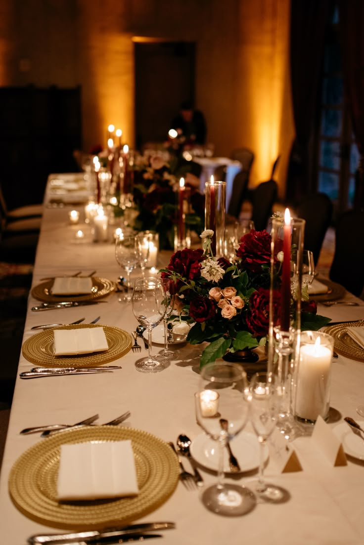 the table is set with place settings and candles