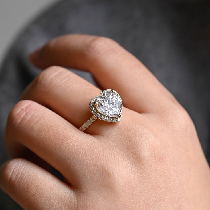 a woman's hand with a diamond ring on it