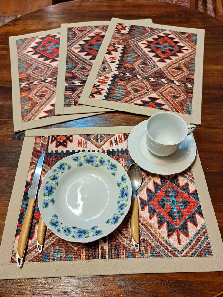 four placemats and two plates on a wooden table