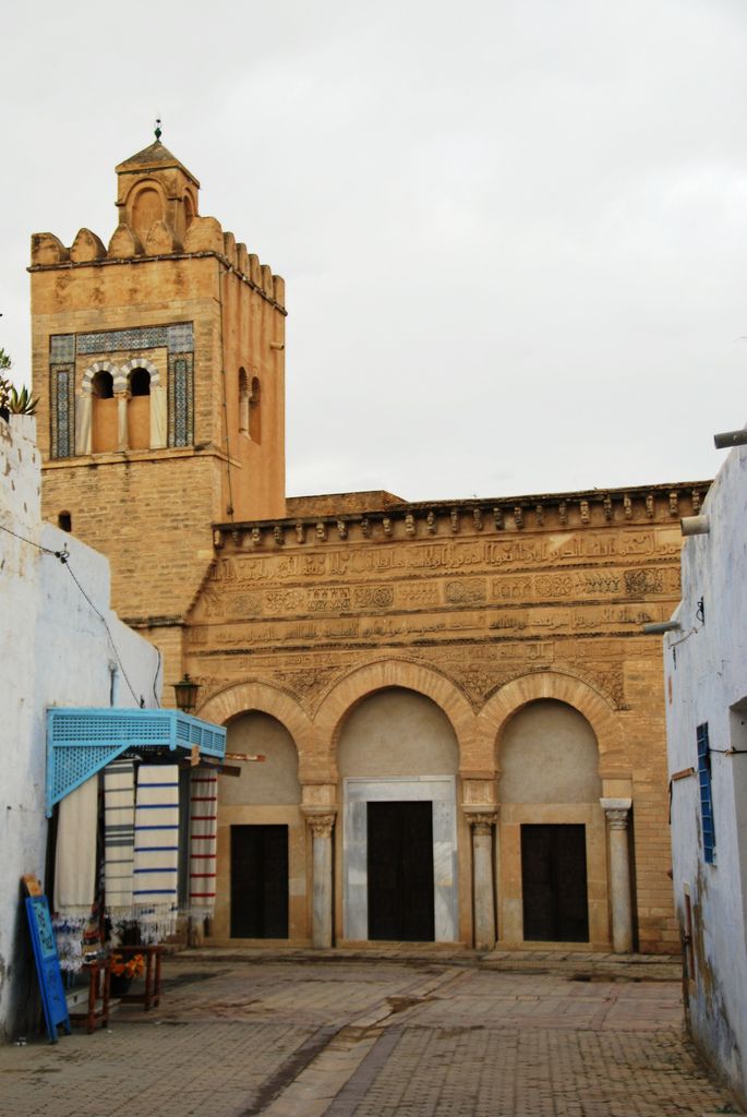 an old building with a clock tower in the background