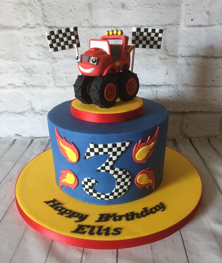 a birthday cake for a three year old boy with a tractor and checkered flag