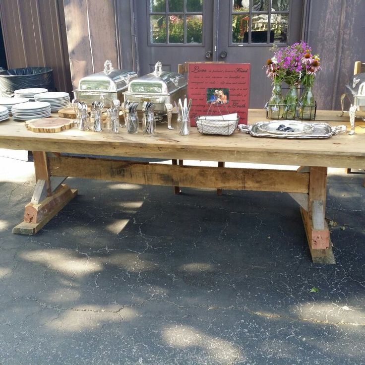 a wooden table with plates and silverware on it