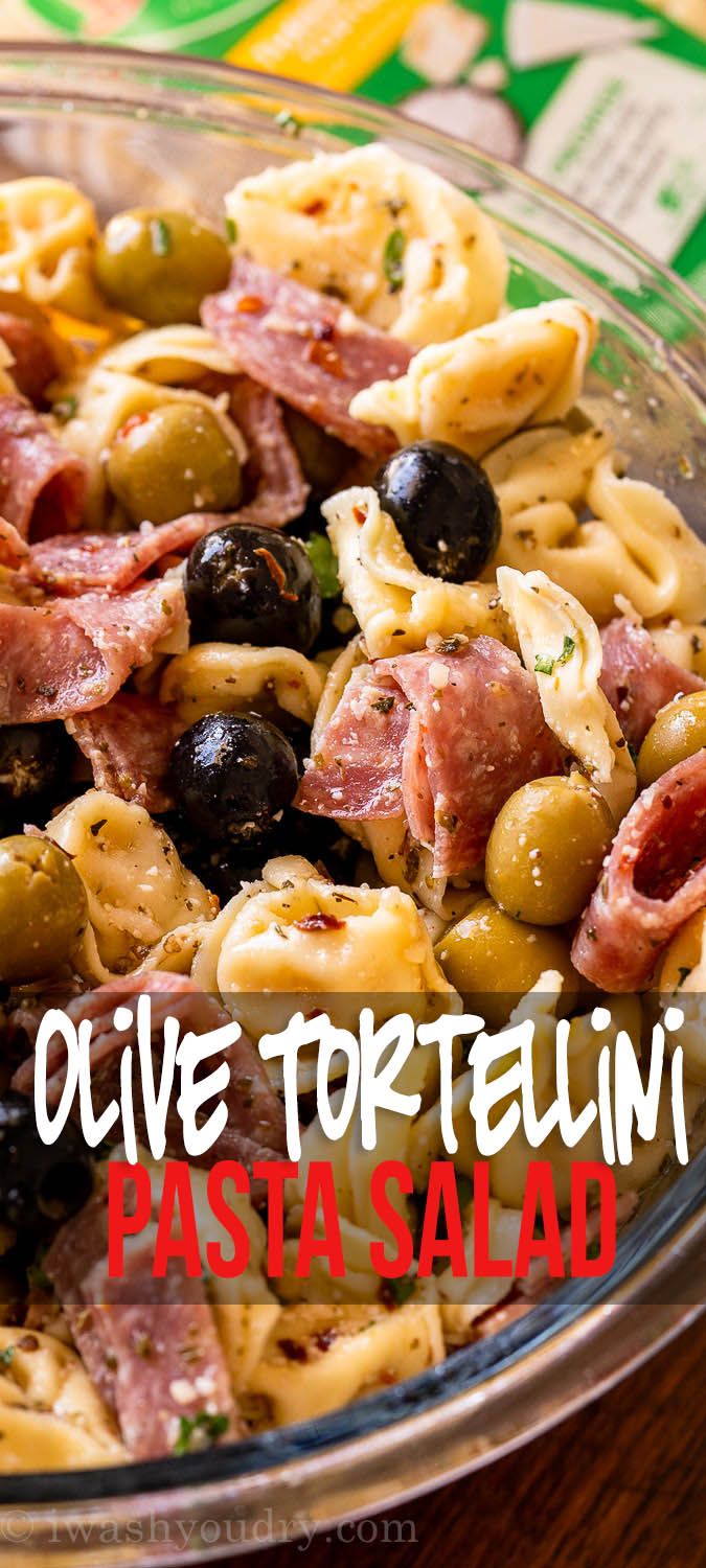 pasta salad with olives and ham in a glass bowl