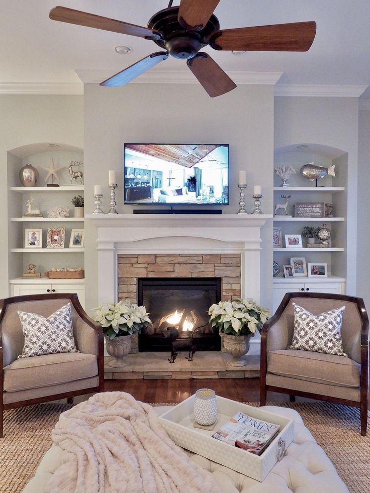 a living room filled with furniture and a flat screen tv mounted above a fire place