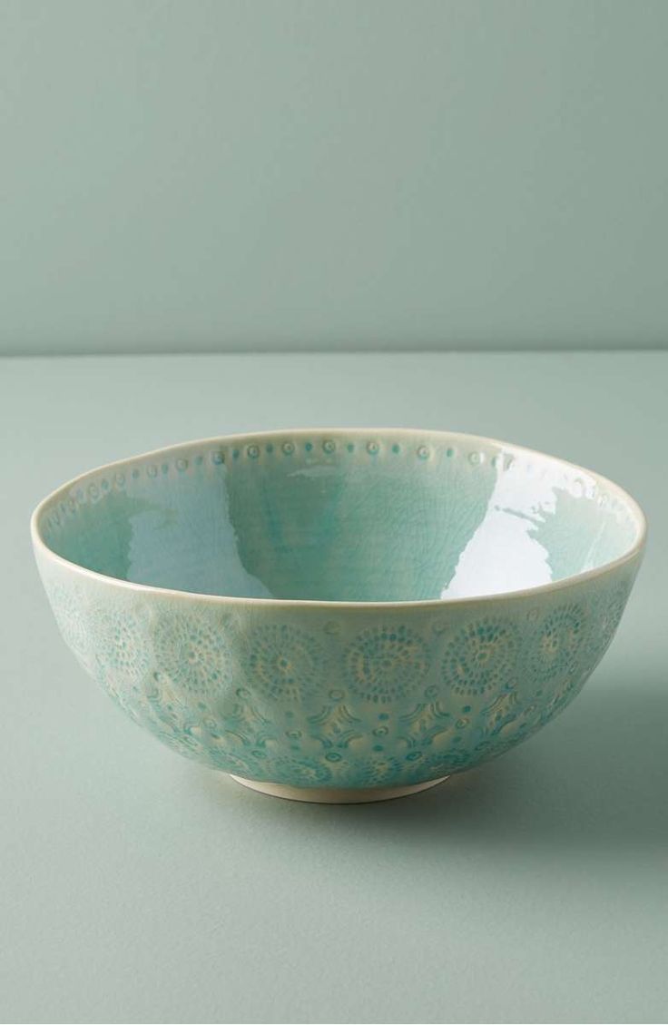 a blue bowl sitting on top of a table