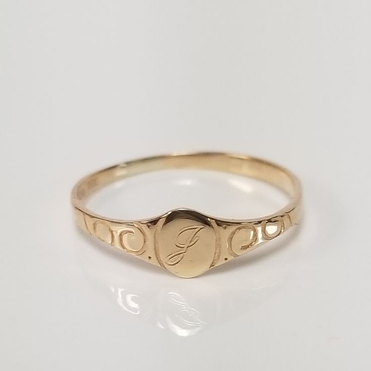 "Thanks for shopping our vintage estate store. We tend to sell well below wholesale and truly hope you enjoy all of our items. Many of the items are one of a kind, so please enjoy scrolling through the pictures and hopefully something will catch your eye. Spots are from camera or reflections. Estate 14k yellow gold cursive J midi baby signet or initial ring. Ring size: 2.75 Setting: 4.5mm 1/4\" Inside diam: 13.3mm Band Width: 1.5mm Weight: .52 gram Marked 14k gold and is a beautiful ring." Antique Gold Oval Engraved Ring, Oval Engraved Ring Stamped 14k For Anniversary, Heirloom Oval Engraved Ring Stamped 14k, Heirloom Oval Engraved Ring With Hallmarks, Oval Heirloom Engraved Ring For Anniversary, Antique Style Initial Ring For Anniversary, Antique Oval Engraved Ring For Gift, Vintage Engraved Promise Ring With Engraving Option, Vintage Engraved Initial Ring For Promise