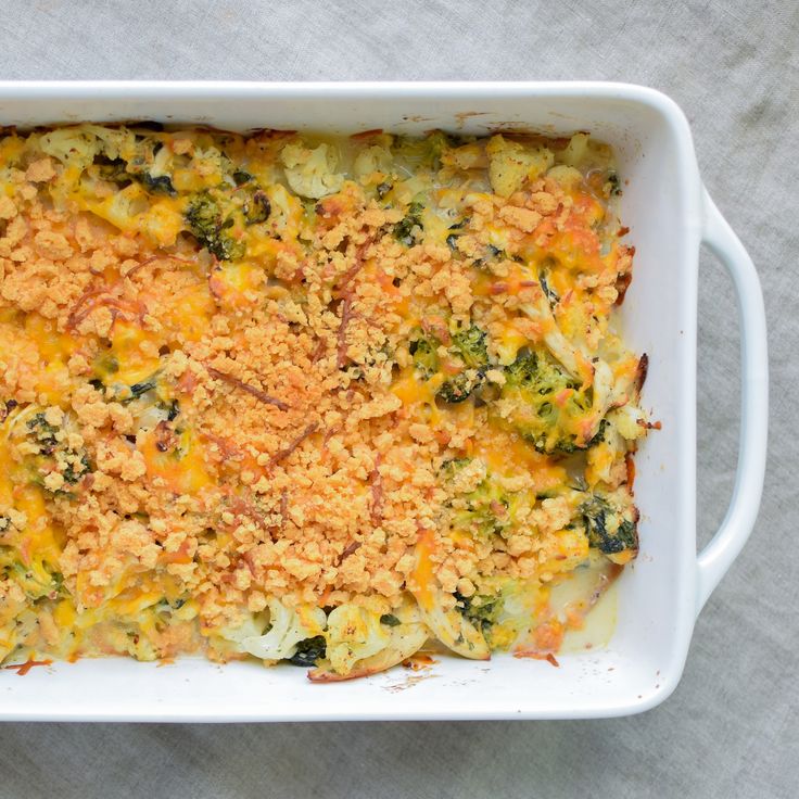 a casserole dish with broccoli, cheese and bread crumbs