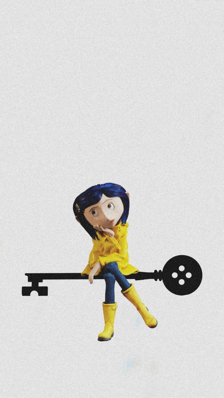 a cartoon figure sitting on top of a key