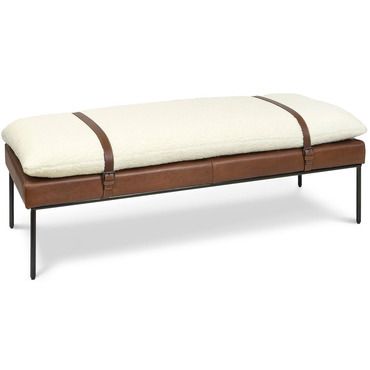 a leather bench with a white cushion and brown straps on the bottom, against a white background