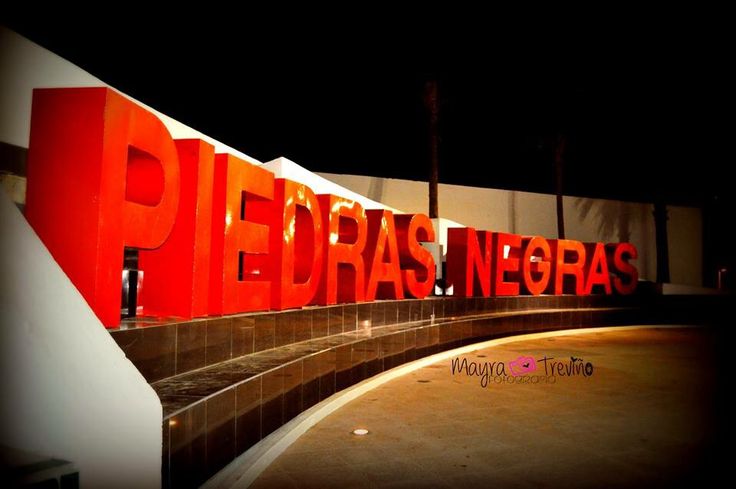 there is a red sign that says peras negras on it at night