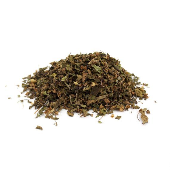 a pile of dried herbs on a white background