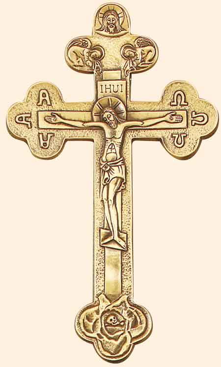 an ornate gold cross with jesus on it