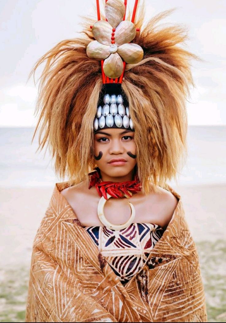 a woman with long hair wearing an elaborate headdress