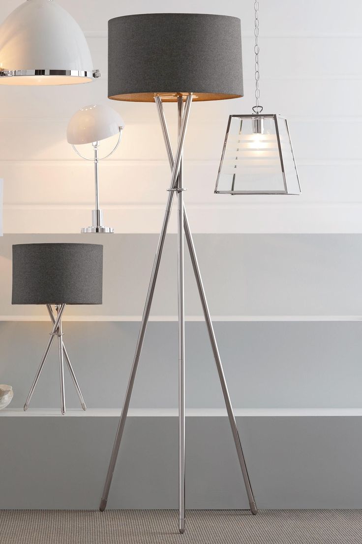 three lamps are sitting on the floor next to each other in a room with white walls