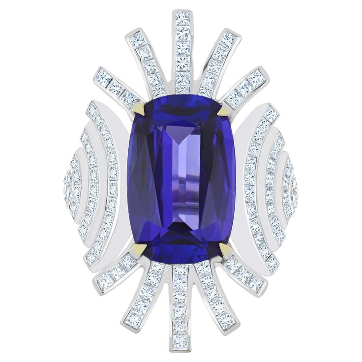 Elegant and Exquisitely detailed White Gold Ring, with a rare 10.4 Cts (approx.) Cushion Round Corner in faceted Cut Tanzanite set in the center beautifully accented with Micro pave set Diamonds, weighing approx. 2.7 CT's (approx.). total carats weight the beauty of the Ring. Beautifully Handcrafted in 18 Karat White Gold Product Details: - Primary Stone: - Tanzanite Primary Stone Shape: - Cushion Round Corner Primary Stone Cut: - Faceted Primary Stone Size: - 117X10.5MM Primary Stone Weight: - Tanzanite And Diamond Ring, Tanzanite Diamond Ring, Tanzanite Diamond, White Gold Ring, Stone Cuts, Micro Pave, Round Corner, White Gold Rings, Tanzania