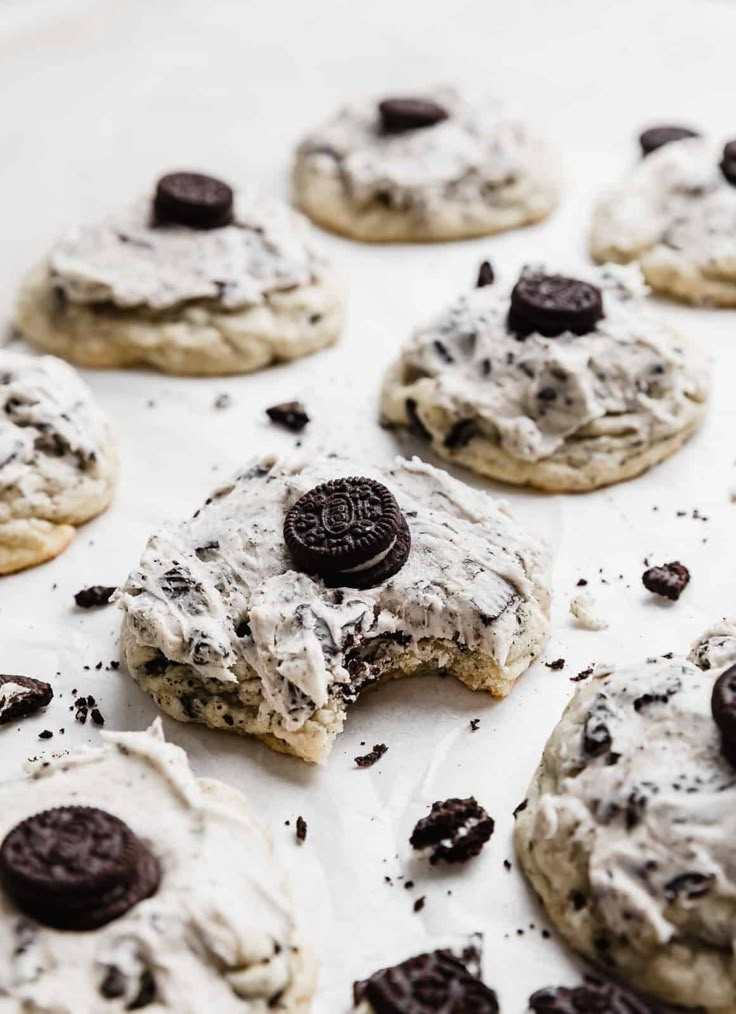 cookies with oreo chips and cream frosting on a baking sheet