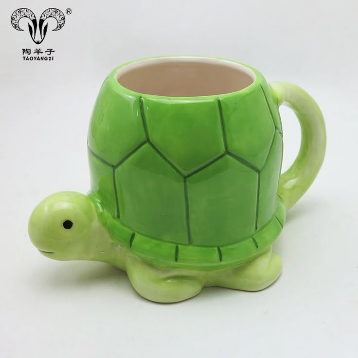 a green ceramic turtle shaped coffee mug