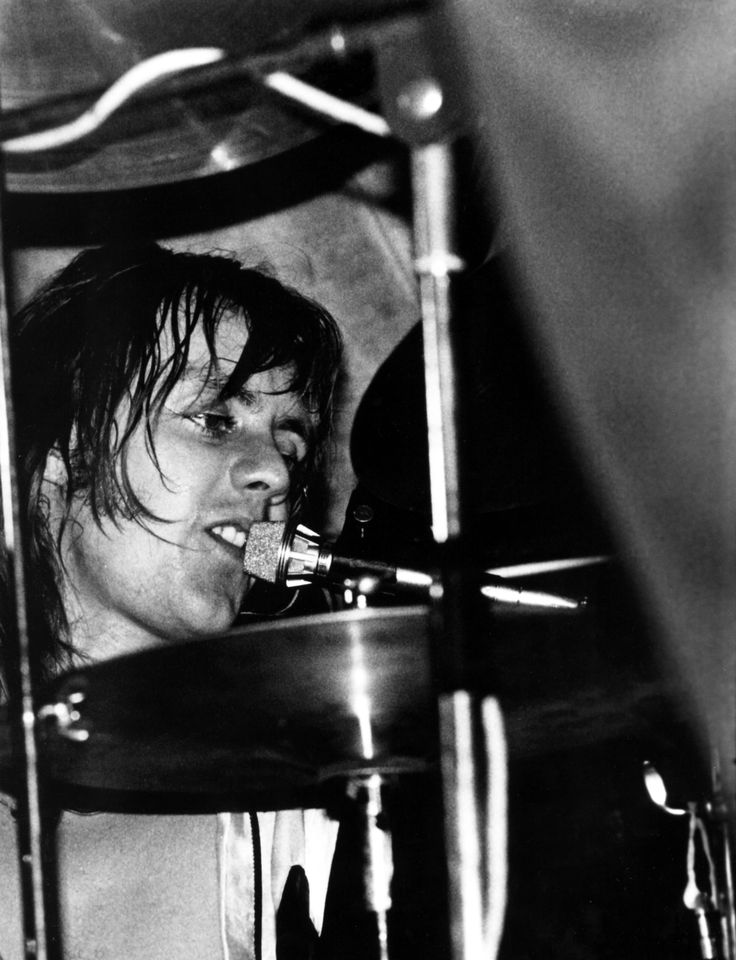 a man with wet hair playing the drums