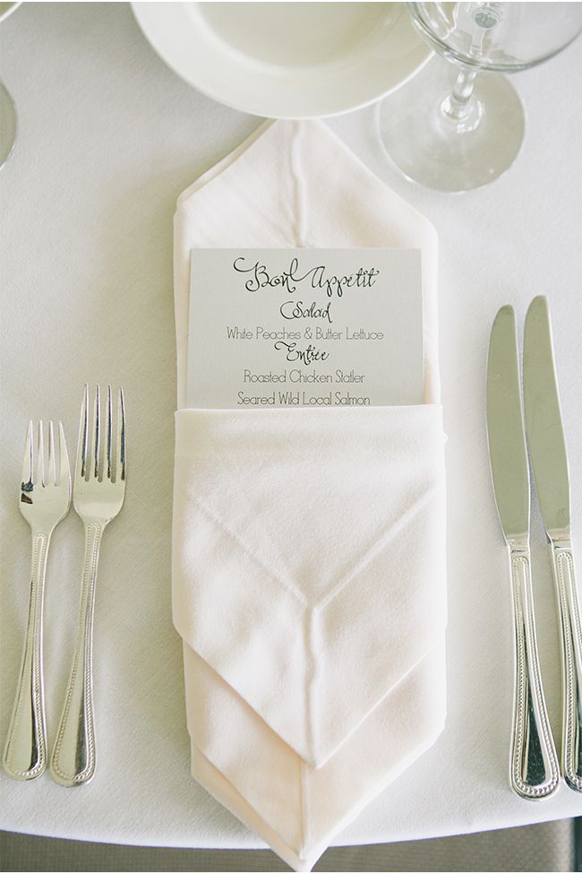 the place setting is set with silverware and napkins for guests to sit at