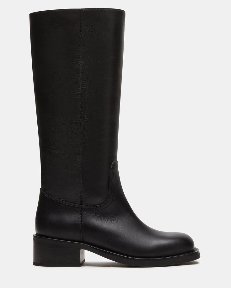 Effortlessly elevate your style with the RIGGS boot. With its square toe and sleek design, this just-under-the-knee boot is a must-have for any fashion-conscious individual. This timeless boot provides both comfort and sophistication, making it the perfect addition to any outfit. 1.75 inch heel height 14.5 inch shaft c Classic Knee-high Platform Boots For Business, Classic Knee-high Platform Boots For Fall, Classic Platform Boots For Fall, Classic Black Knee-length Boots, Classic Mid-calf Workwear Boots, Winter Square Toe Calf Leather Knee-high Boots, Winter Calf Leather Knee-high Boots With Square Toe, Winter Square Toe Knee-high Calf Leather Boots, Under The Knee Boots