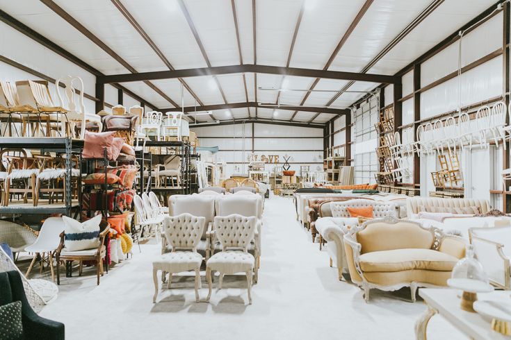 a large room filled with lots of furniture and chairs in it's center aisle