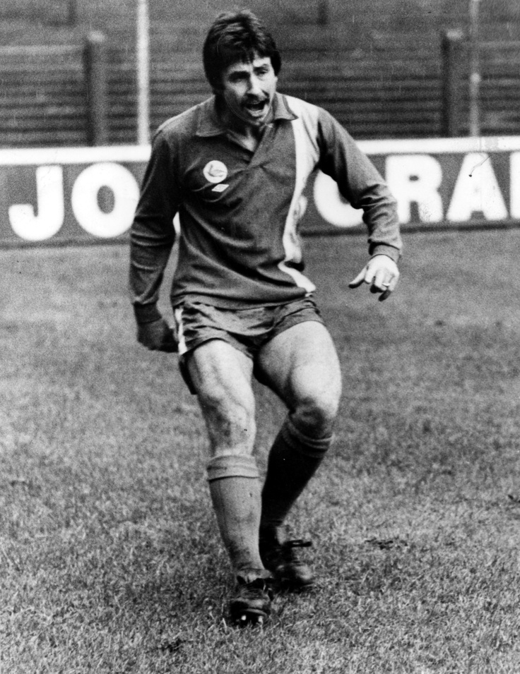 an old black and white photo of a man playing soccer