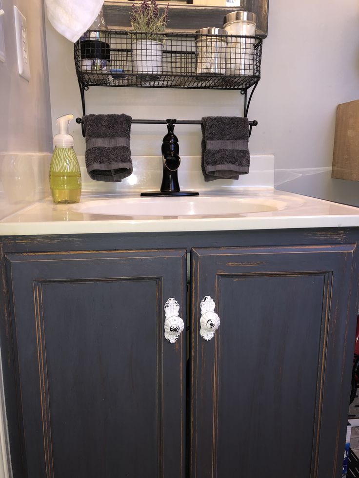 a bathroom sink with towels hanging on the rack above it