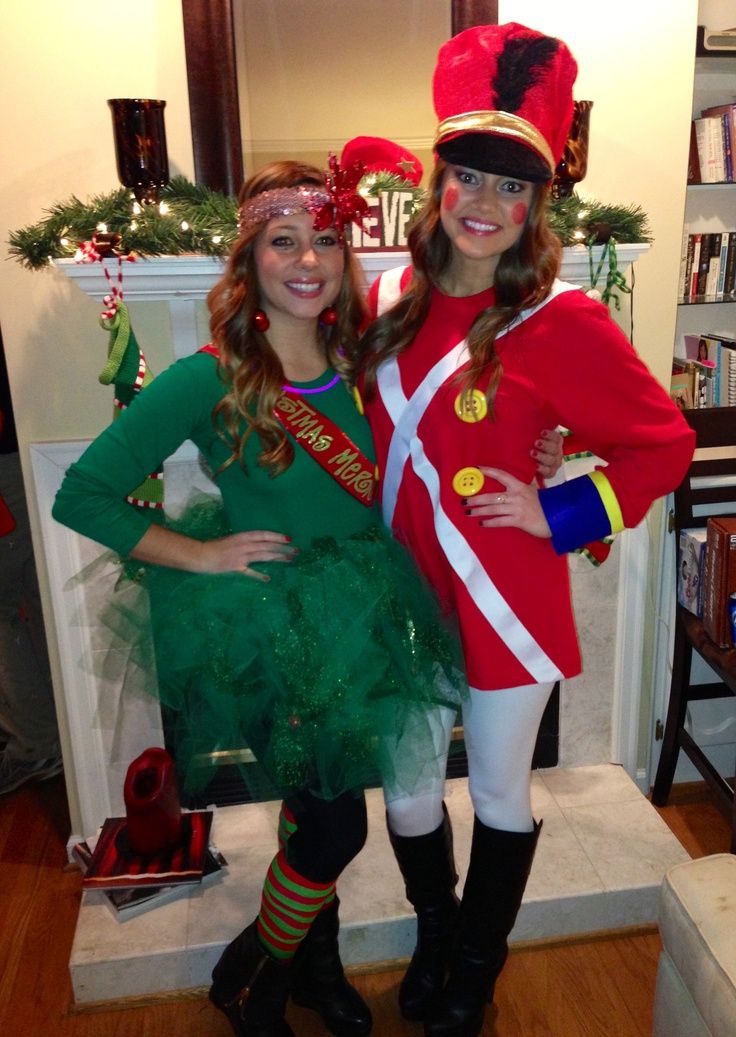 two women dressed in costumes standing next to each other