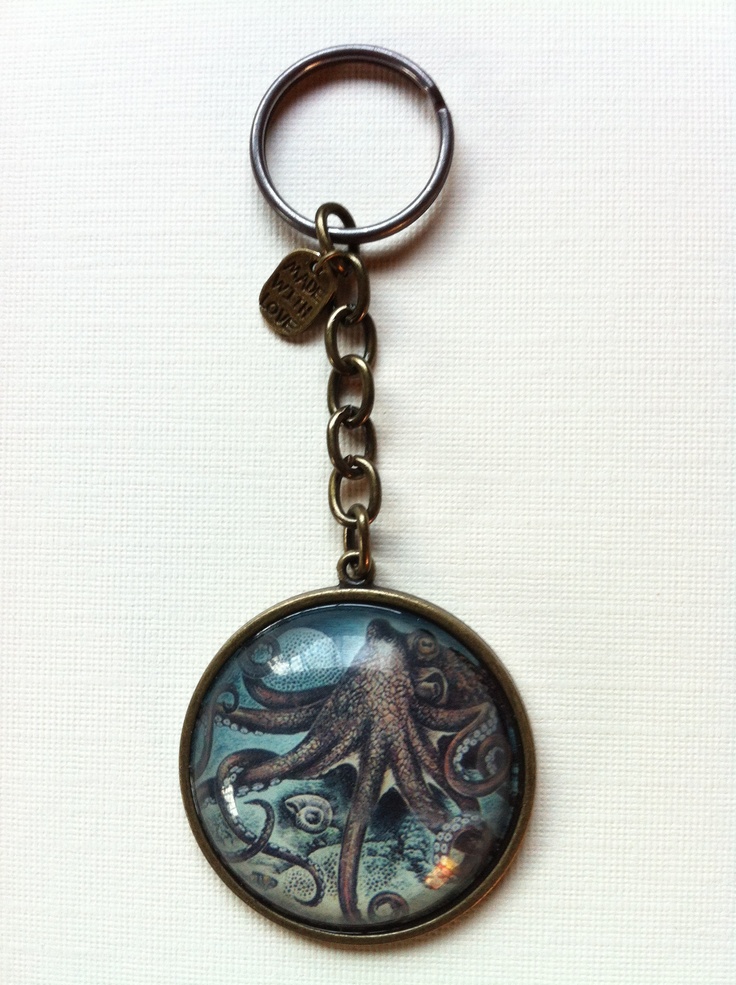 an octopus keychain is shown on a white surface with a black and blue design