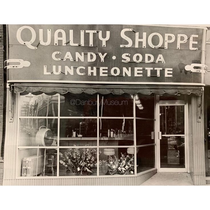 an old black and white photo of a store front