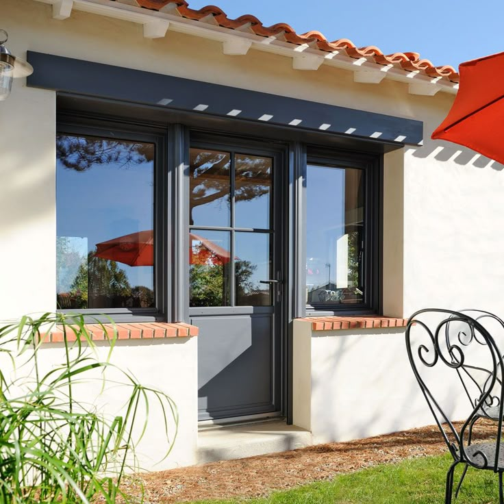 an open patio door and table with an umbrella