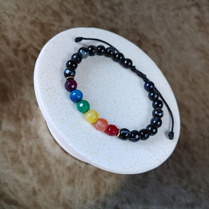 LGBTQ Rainbow Gemstone Bracelet - Discreet Pride Bracelet, Adjustable Cord Jewelry, Handmade Gift for Women's & Men's LGBTQ Rainbow Bracelet, a stunning Pride Gemstone Bracelet featuring the iconic Gay Flag colors. This Adjustable String Bracelet, handmade with care, makes for a perfect Pride Month Gift or a thoughtful Christmas Gift for Her and Him. Details: - Minimalist, elegant, and casual design. - Crafted with 6mm rainbow color agate and black agate stones, hematite beads. - Adjustable fit Adjustable Rainbow Gemstone Bracelet, Adjustable Rainbow Bracelets With Gemstone Beads, Rainbow Bracelet Jewelry For Healing, Adjustable Rainbow Bracelets With 8mm Beads, Adjustable Rainbow Crystal Bracelet, Adjustable Rainbow Gemstone Beads Bracelet, Adjustable Rainbow Gemstone Beaded Bracelets, Adjustable Rainbow Bangle, Rainbow Colored Bangle Jewelry Gift