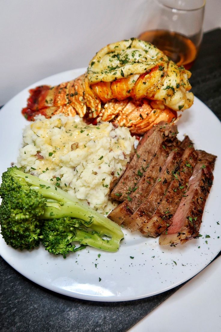 a white plate topped with meat, rice and broccoli